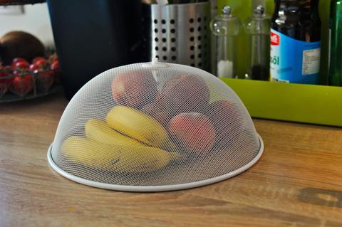 Fruit stored under a mesh dome to deter fruit flies